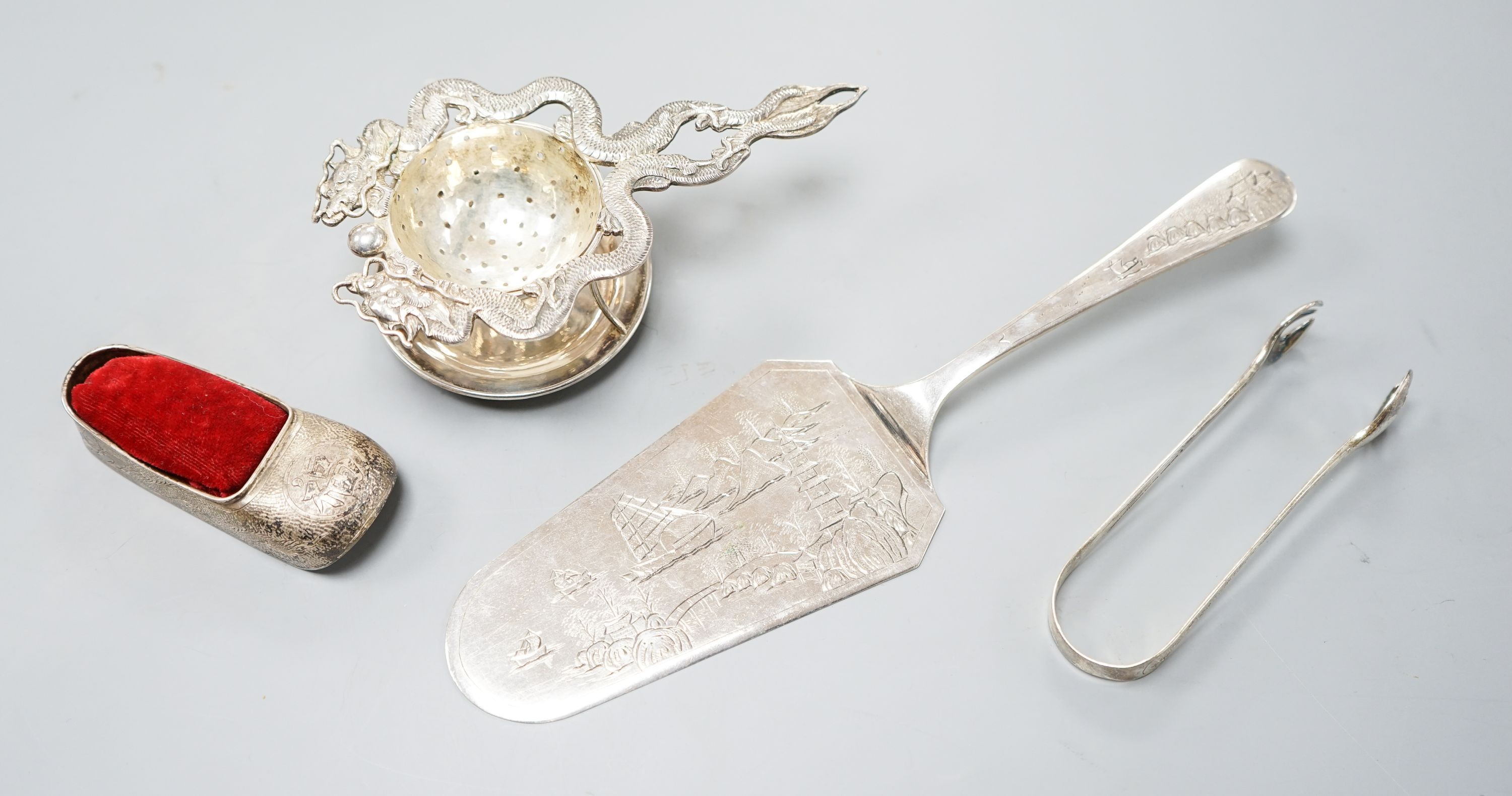 A Chinese white metal cake slice by Tack Hing, 24.4cm and a tea strainer on stand, pair of sugar tongs and pin cushion by Kingsburg, Hong Kong.